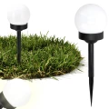 lampa-solarna-led-kula-neutralny-bialy-czarna-w-trawie.webp